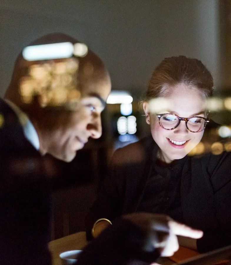 Colleagues reading from computer screen