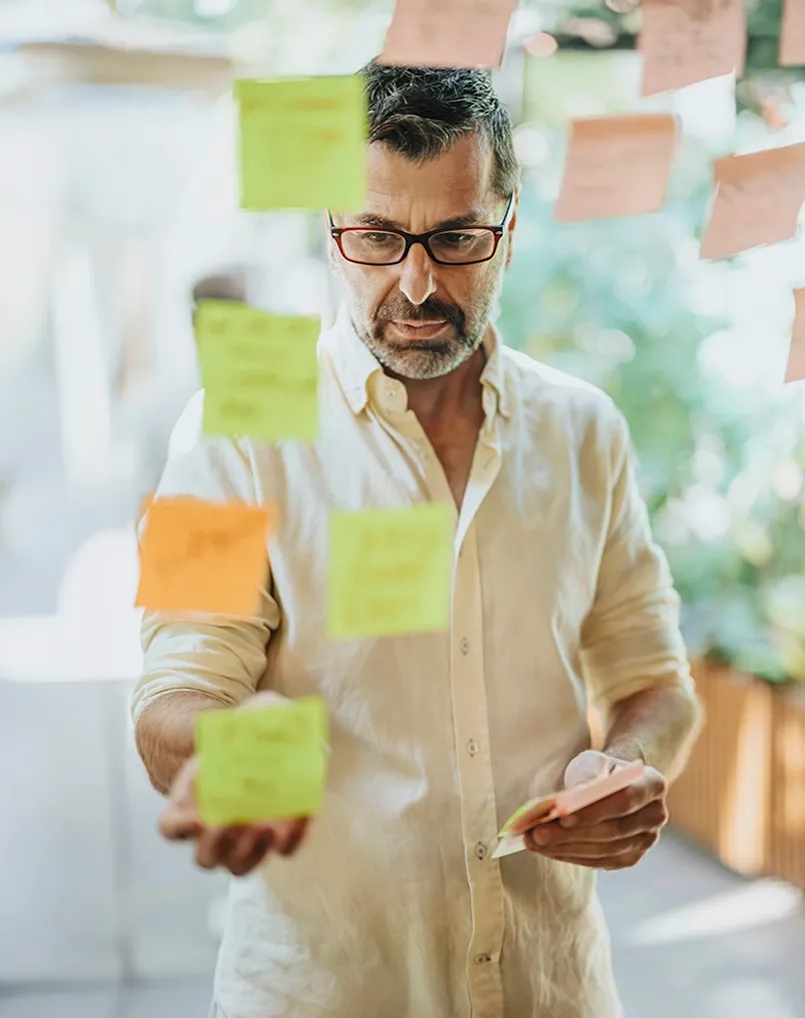 Logistics manager planning with post-it notes